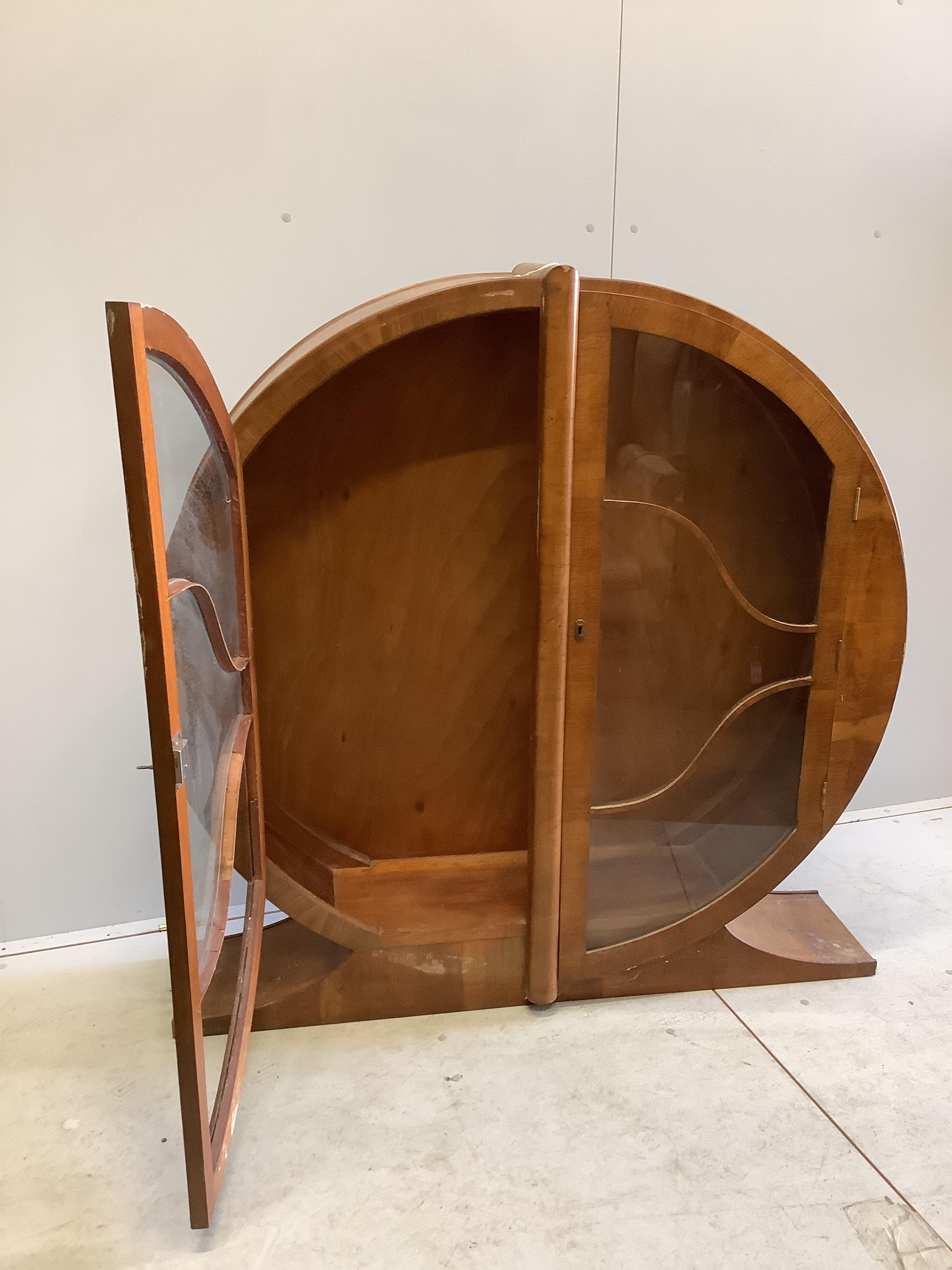 An Art Deco circular walnut veneered display cabinet, width 126cm, depth 30cm, height 125cm